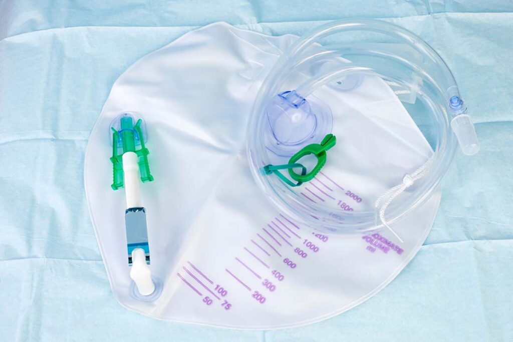 Close-up of a urinary catheter on top of a blue cloth.